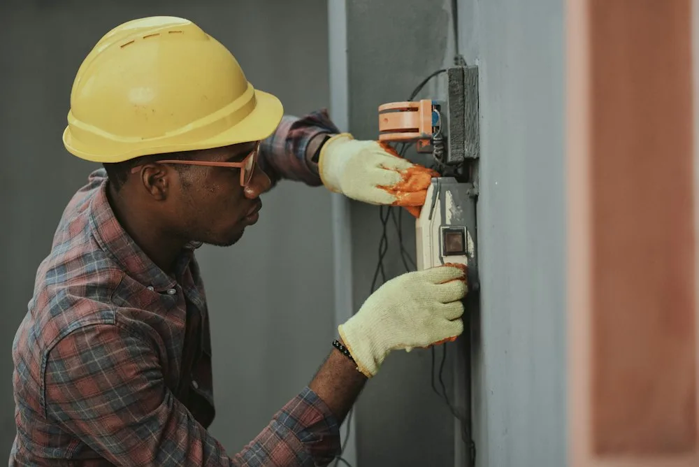 Appliance technician working on washer dryer in Garland home